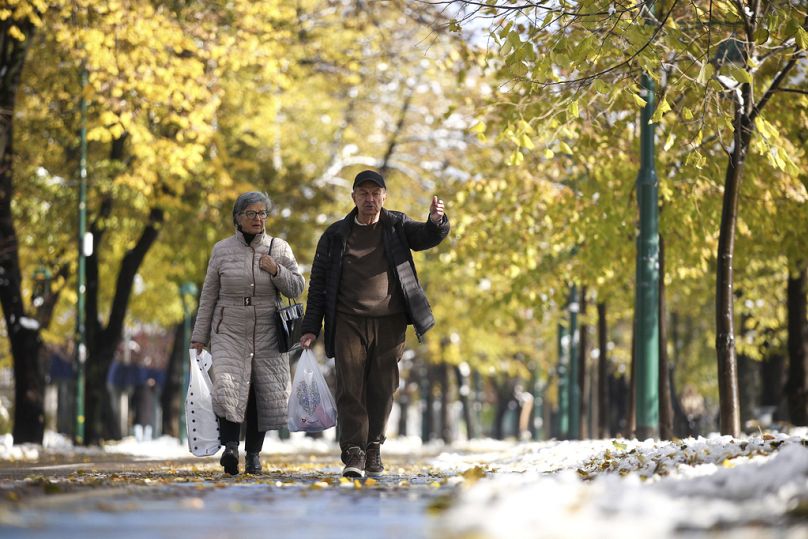 An elderly couple walks on Wilson's Promenade after a snowfall in Sarajevo, 21 November 2024