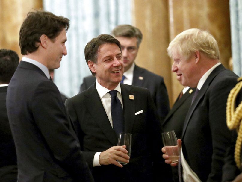 Boris Johnson talks to Canadian Prime Minister Justin Trudeau, left, and Italian Prime Minister Giuseppe Conte during a reception at Buckingham Palace, London, 2019.