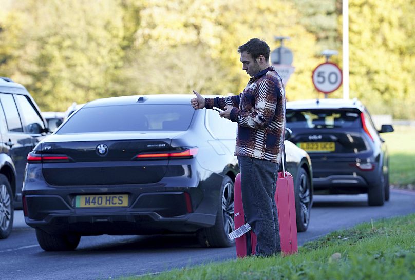 A passenger hitchhikes at Gatwick airport where flights were cancelled and delayed after a 'suspected prohibited item' was found in luggage, 22 November, 2024