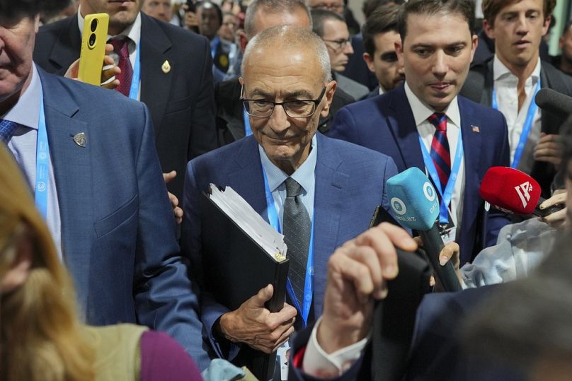 John Podesta, US climate envoy, walks through a crowd during the COP29.