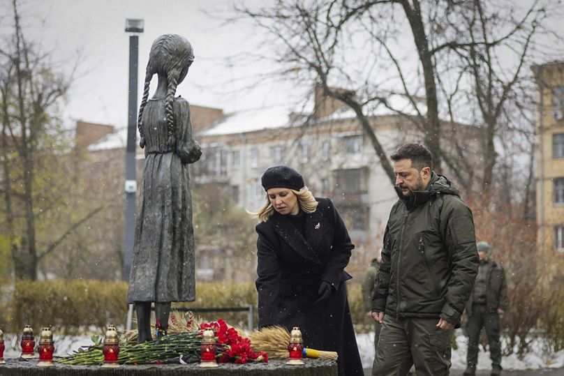 Ukrainian President Volodymyr Zelenskyy and his wife Olena pay their tribute at a monument to victims of the Holodomor.