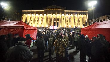 Protesters gather in front of the parliament building in Tbilisi during a rally to demand new elections, 24 November, 2024