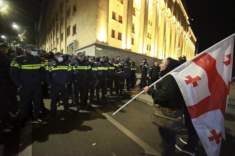 A protester waves the Georgian flag during an anti-government rally in Tbilisi, 24 November, 2024