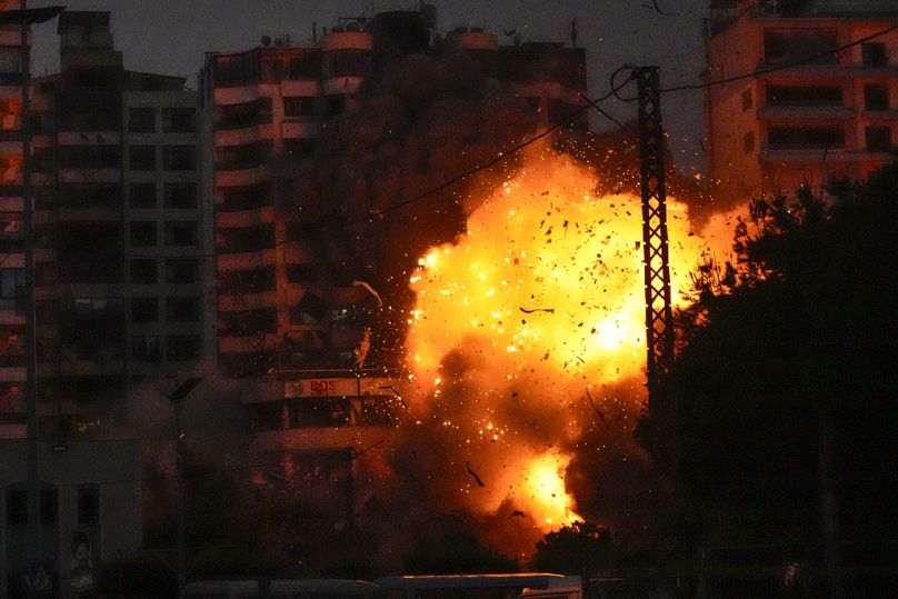 Thick smoke, flames and debris erupt from an Israeli airstrike that targeted a building in Tayouneh, Beirut, Lebanon, Monday, Nov. 25, 2024. 