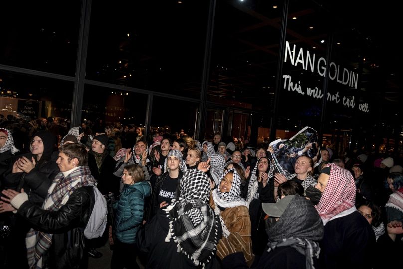Pro-Palestinian supporters gather in front of the the Neue Nationalgalerie museum at the opening of the exhibition "Nan Goldin. This Will Not End Well" in Berlin.