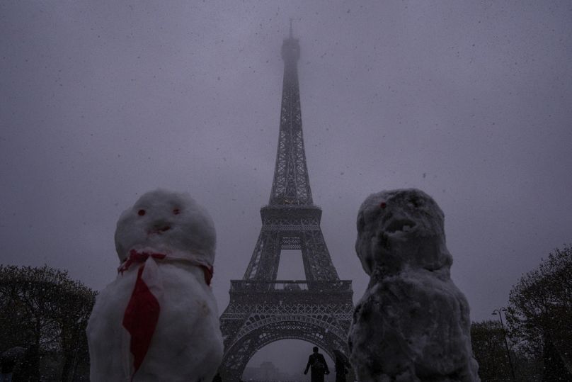 Snow figures are seen near to the Eiffel Tower in Paris