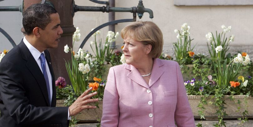 US President Barack Obama shares a word with German Chancellor Angela Merkel as they stroll on the market place in Baden-Baden, Germany on Friday, April 3, 2009