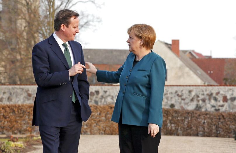 German Chancellor Angela Merkel, right, and Britain's Prime Minister David Cameron chat in Berlin, April 2013