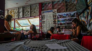 Foreign tourists relax at a bar and restaurant in Vang Vieng, Laos, Friday, Nov. 22, 2024. 