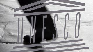 The United Nations Educational, Scientific and Cultural Organisation (UNESCO) logo is seen on a glass door at the UNESCO headquarters in Paris, Saturday Sept. 19, 2009. 
