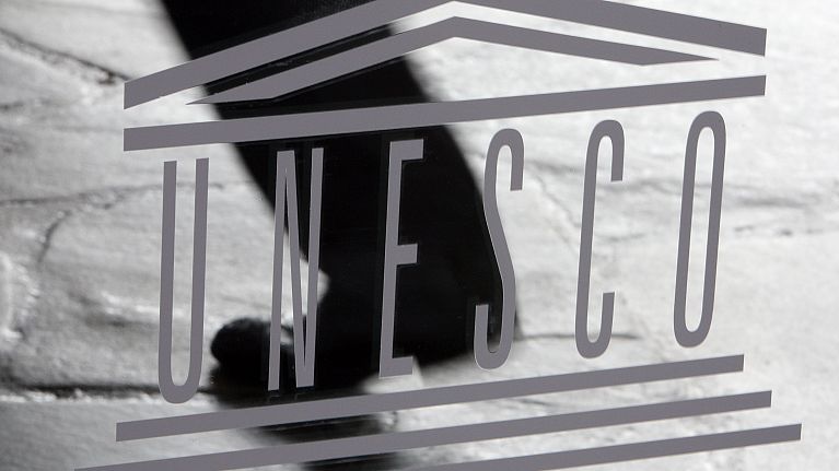 The United Nations Educational, Scientific and Cultural Organisation (UNESCO) logo is seen on a glass door at the UNESCO headquarters in Paris, Saturday Sept. 19, 2009. 