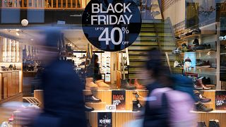 People pass a shop advertising a Black Friday Sale on Oxford Street in London, Wednesday, Nov. 27, 2024. (AP Photo/Kirsty Wigglesworth)