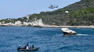 A helicopter and a vessel with coast guards officers take part in a search and rescue operation in Greece on 23 September 2024. 