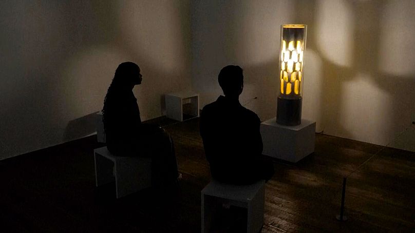 Visitors observe 'Dreammachine no. 9' by Brion Gysin at Tate Modern in London. 