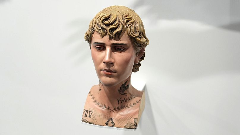A wood carved sculpture portraying Justin Bieber's tattooed body parts titled "Incarnator," by artist Paul Pfeiffer