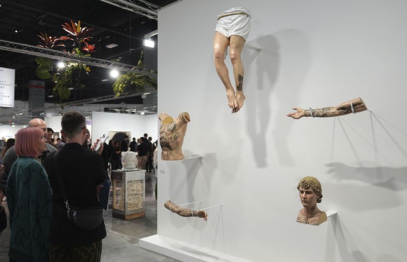 A wood carved sculpture portraying Justin Bieber's tattooed body parts titled "Incarnator," by artist Paul Pfeiffer, displayed during Art Basel Miami Beach. 