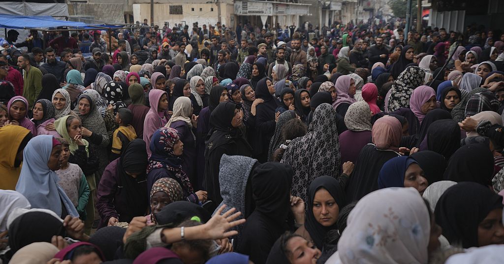 Palestinian children line up in Gaza Strip hoping to be distributed a warm meal