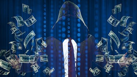 A stock image of a scammer collecting money through online pig butchering schemes 