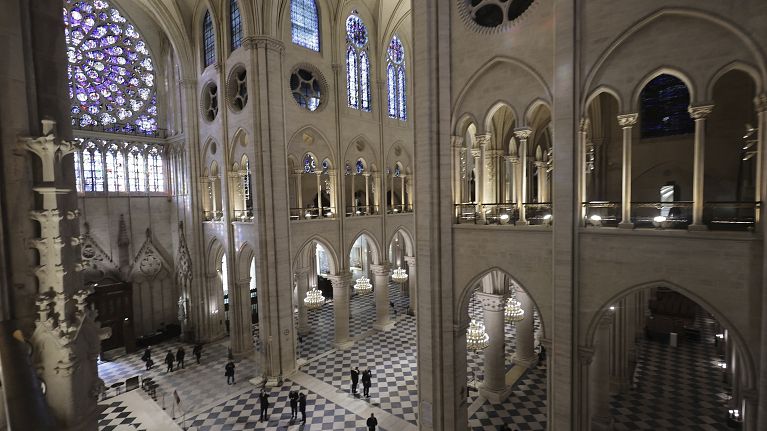 People stroll in Notre-Dame de Paris cathedral while French President Emmanuel Macron visits the restored interiors the monument, Friday, Nov.29, 2024 in Paris.