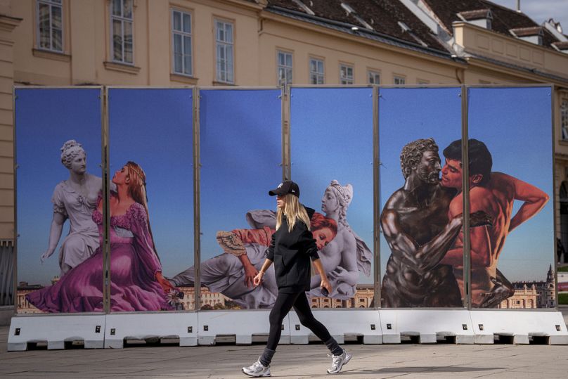 A woman walks by artwork on display in the Museum Quartier in Vienna, September 2024