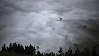 A church tower rises through the fog in Bruelisau, Switzerland. 4 November 2024.