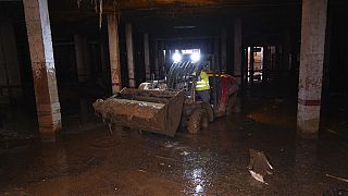 Mud is scooped up after floods in Catarroja that left hundreds dead or missing in the Valencia region in Spain, Tuesday, Nov. 12, 2024.