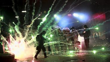 Demonstrators use firecrackers against police during a protest in Tbilisi, 30 November, 2024