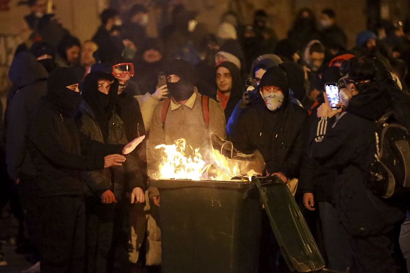 Demonstrators warm themselves by a fire during a rally in Tbilisi, 2 December, 2024