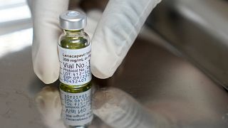 FILE - A pharmacist holds a vial of lenacapavir, the new HIV prevention injectable drug, at the Desmond Tutu Health Foundation's Masiphumelele Research Site, in Cape Town.