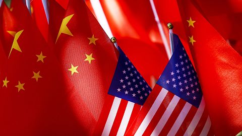 US flags are displayed with Chinese flags on top of a trishaw on September 16, 2018, in Beijing.