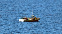 Migrants are seen on board of a rubber boat during a rescue operation in the international waters of the central Mediterranean, 28 Novemever 2024.