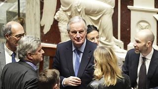 French Prime Minister Michel Barnier, center, in the National Assembly before French lawmakers vote on a no-confidence motion on Dec. 4, 2024 in Paris.