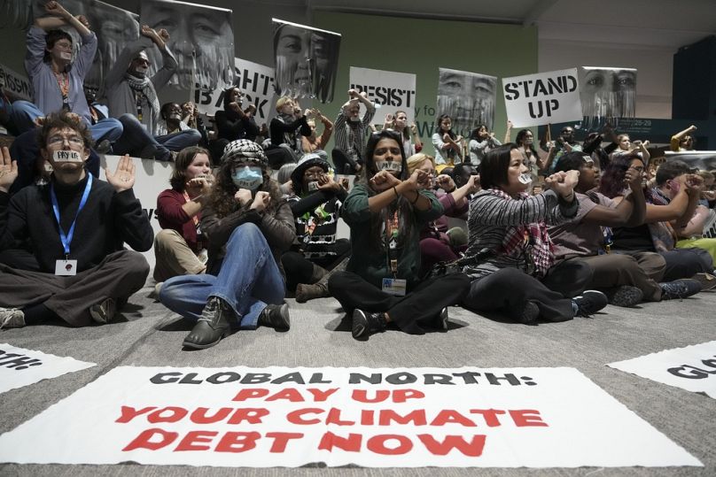 Activists participate in a demonstration for climate finance at COP29.