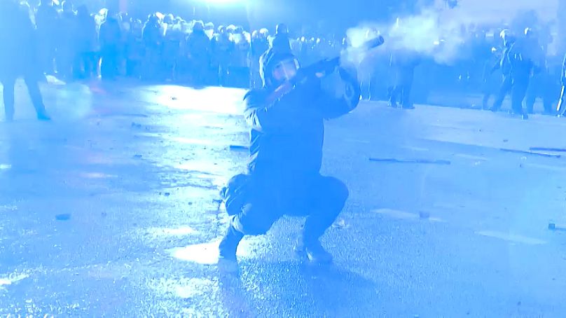 Un policier tire une grenade lacrymogène sur la foule dans le centre de Tbilissi 