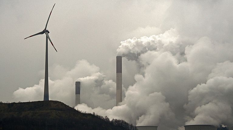 A wind turbine overlooks a coal-fired power station in Gelsenkirchen, Germany A wind turbine overlooks a coal-fired power station in Gelsenkirchen, Germany