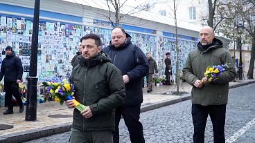 President Volodymyr Zelensky lays flowers at the memorial wall for the fallen soldiers of Ukraine, in Kyiv, Ukraine, 6 December 2024.