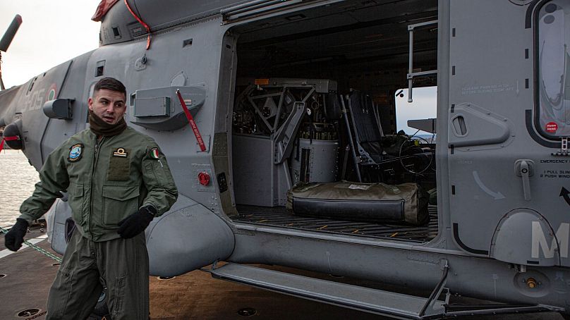 A naval aviation Italian soldier showcases a helicopter used by anti-submarine missile frigate Carabiniere to patrol the sea, during a recent trip to Oslo. 