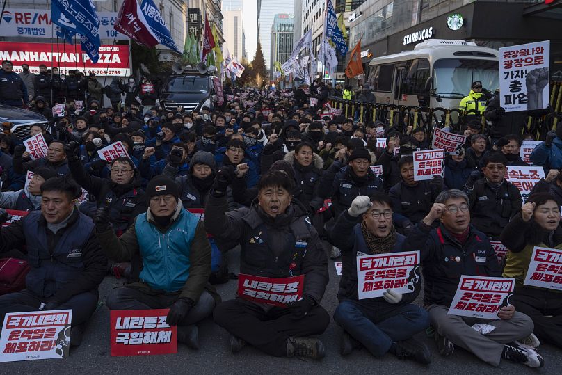 Protesters against South Korean President Yoon Suk Yeol gather outside the ruling People Power Party headquarters in Seoul, 6 December, 2024