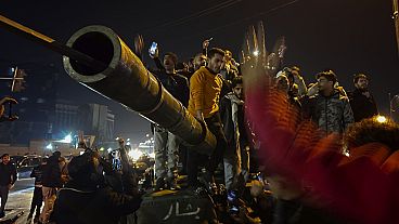 Syrians celebrate the arrival of opposition fighters in Damascus, Syria, Sunday Dec. 8, 2024.