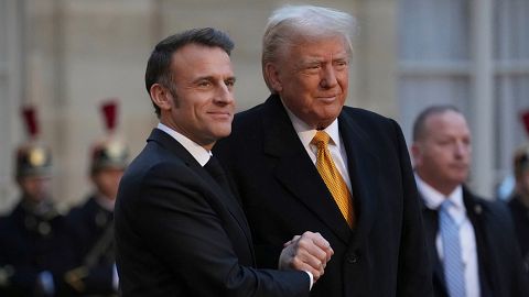 French President Emmanuel Macron, left, welcomes President-elect Donald Trump as he arrives at the Elysee Palace, Saturday, Dec. 7, 2024 in Paris.