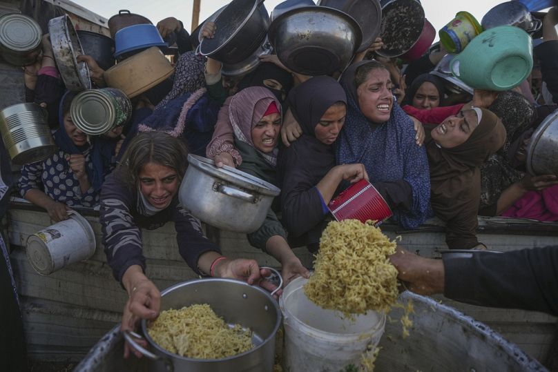 فتيات فلسطينيات يكافحن للحصول على الطعام في مركز توزيع في خان يونس، قطاع غزة، يوم الجمعة، 6 ديسمبر، 2024.