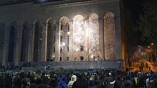 Manifestanti lanciano petardi contro il Parlamento durante una protesta contro la decisione del governo di sospendere i negoziati per l'adesione all'Unione Europea a Tbilisi