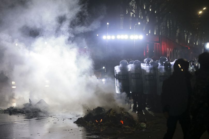 Police use a water cannon to clear protesters during a rally outside the parliament to protest the government's decision to suspend negotiations on joining the European Union