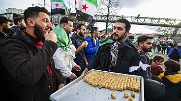 Syrians celebrate the fall of the government of Syrian President Bashar al-Assad during a spontaneous rally in Wuppertal, Germany, 8.12.2024