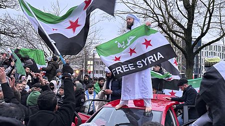 People celebrate the fall of the Assad regime, in Rostock, Germany, Sunday, Dec. 8, 2024.