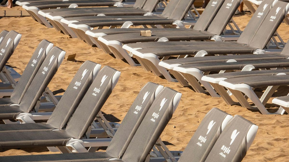 Hundreds of sunbeds graffitied in Tenerife in tourism protest