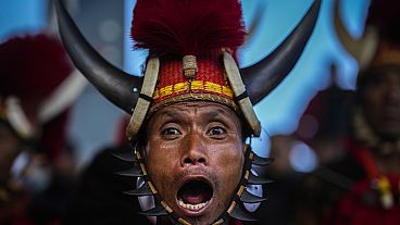 A member of the indigenous Naga tribe sings during the Hornbill festival in Kisama, India, 10.12.2024