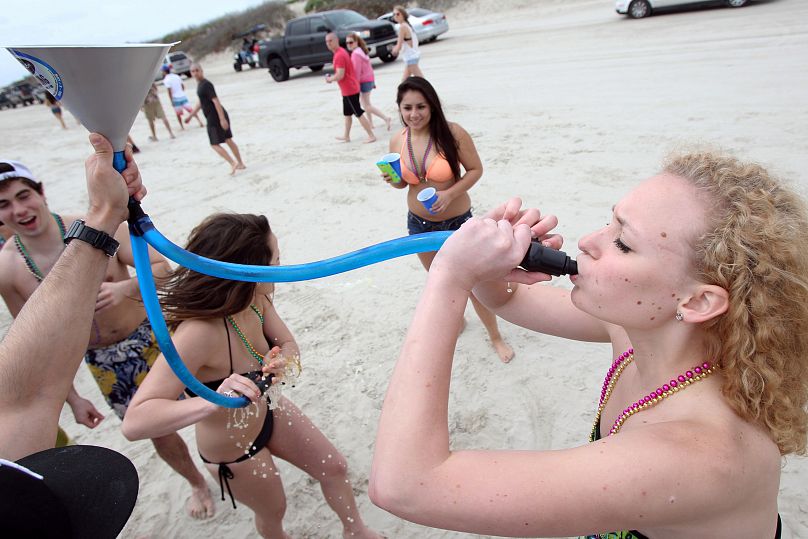 Two revellers celebrate spring break on the beach in Port Aransas, Texas. March 11, 2014