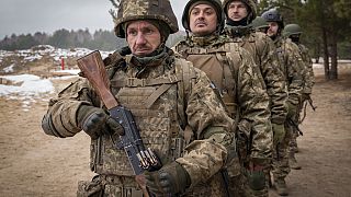 New recruits practice on a military training ground in Chernihiv region, Ukraine, Thursday, Dec. 5, 2024.