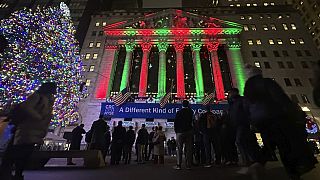 People gather in front of the New York Stock Exchange in New York's Financial District on Tuesday, Dec. 10, 2024.